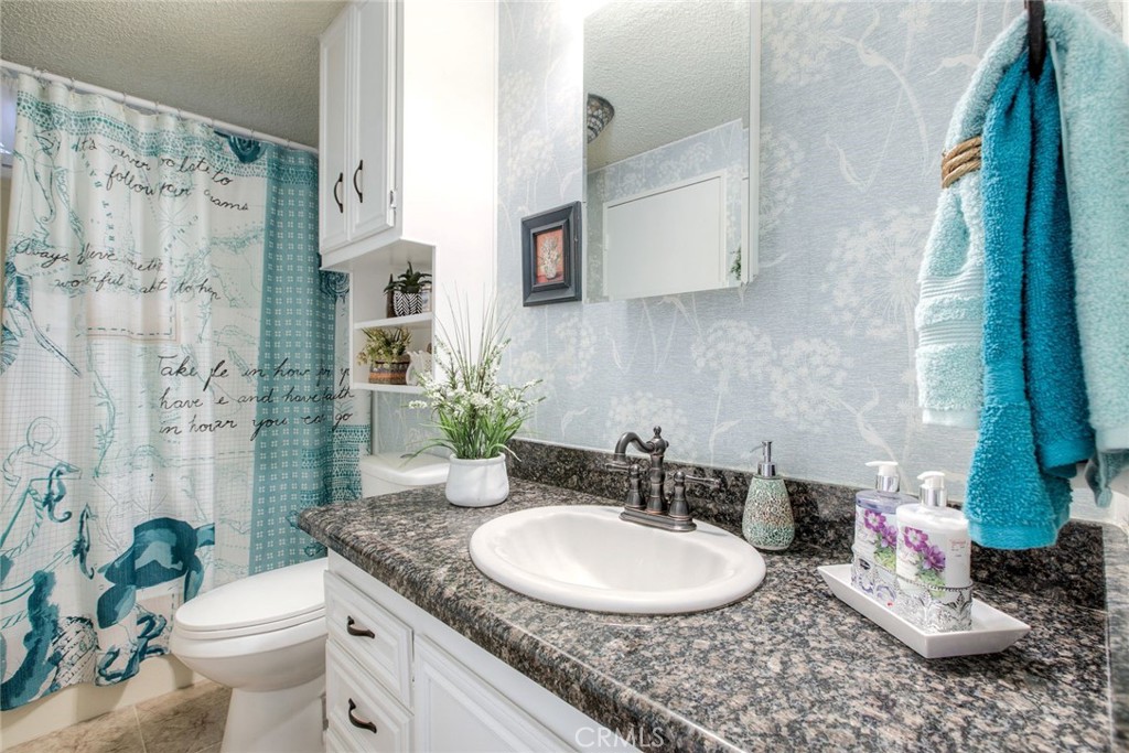 34370 The Farm Road Wildomar, CA 92595 - Photo 25 of 31 a bathroom with a granite countertop sink and a mirror