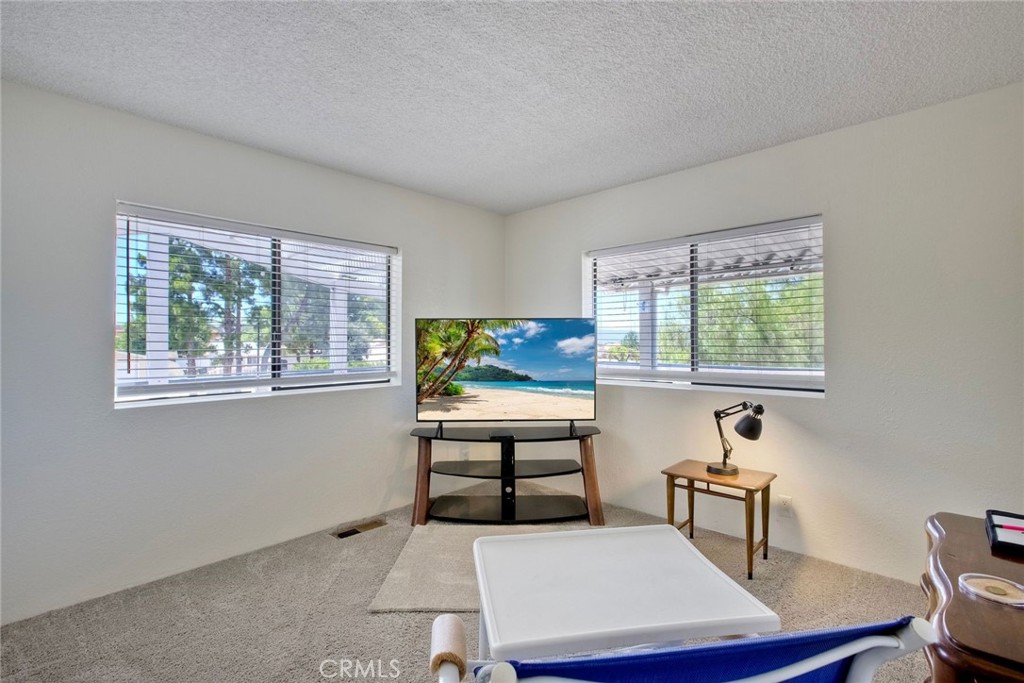 34370 The Farm Road Wildomar, CA 92595 - Photo 29 of 31 a living room with furniture a window and a flat screen tv