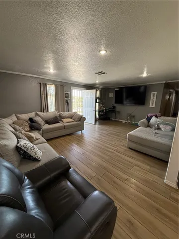a kitchen with stainless steel appliances wooden floor and large windows