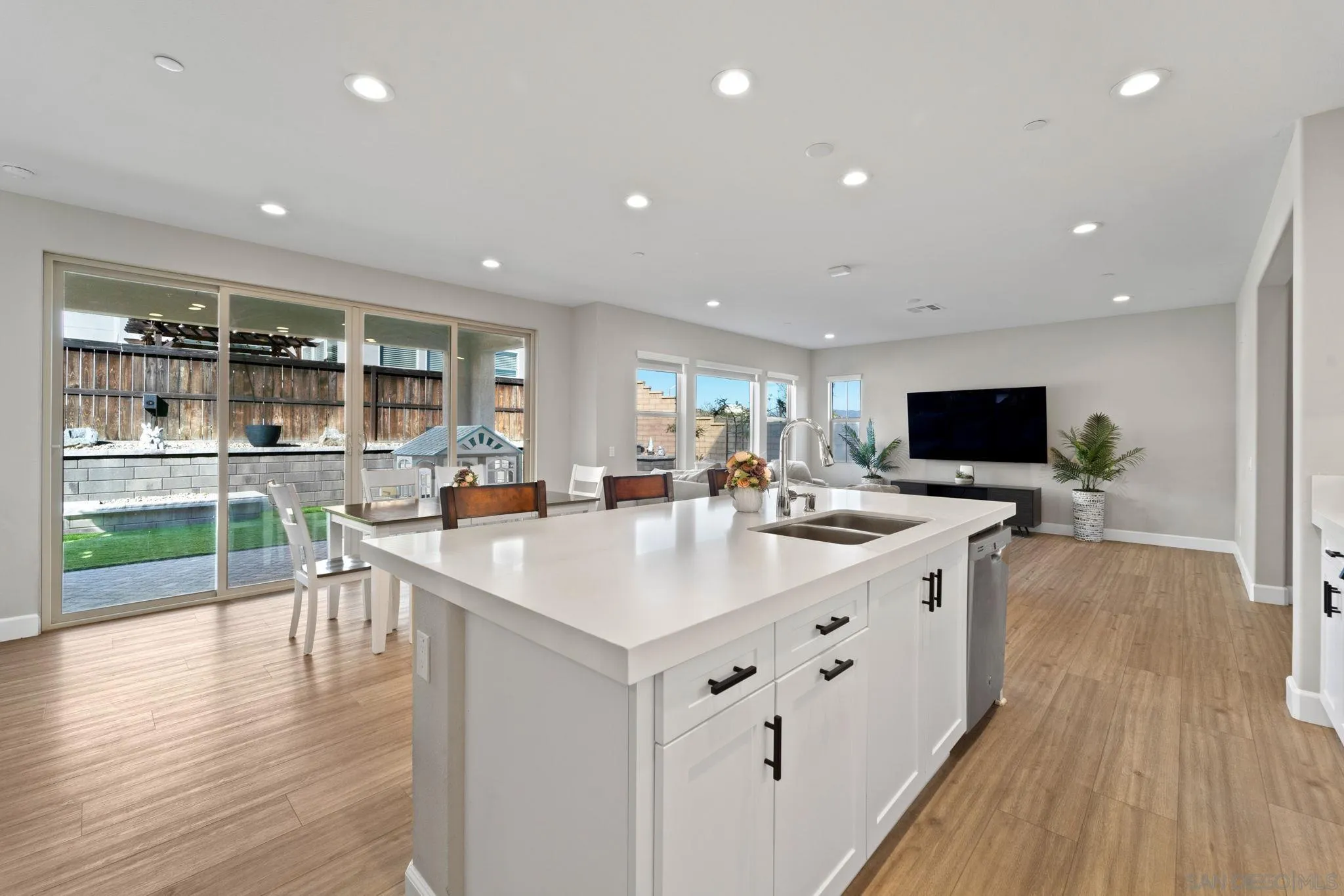 1279 Camino Prado Chula Vista, CA 91913 - Photo 11 of 38 a large white kitchen with a large island in the center