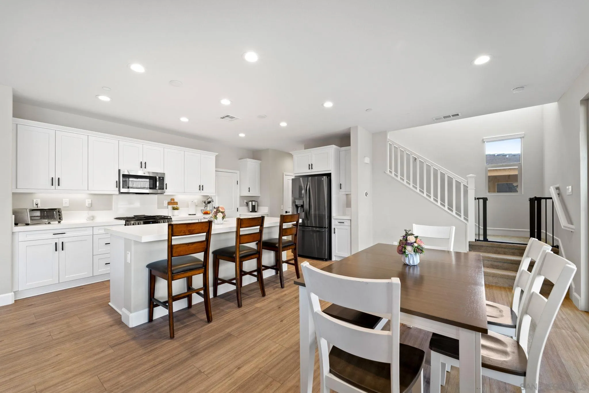 1279 Camino Prado Chula Vista, CA 91913 - Photo 13 of 38 a view of a dining room with furniture and wooden floor