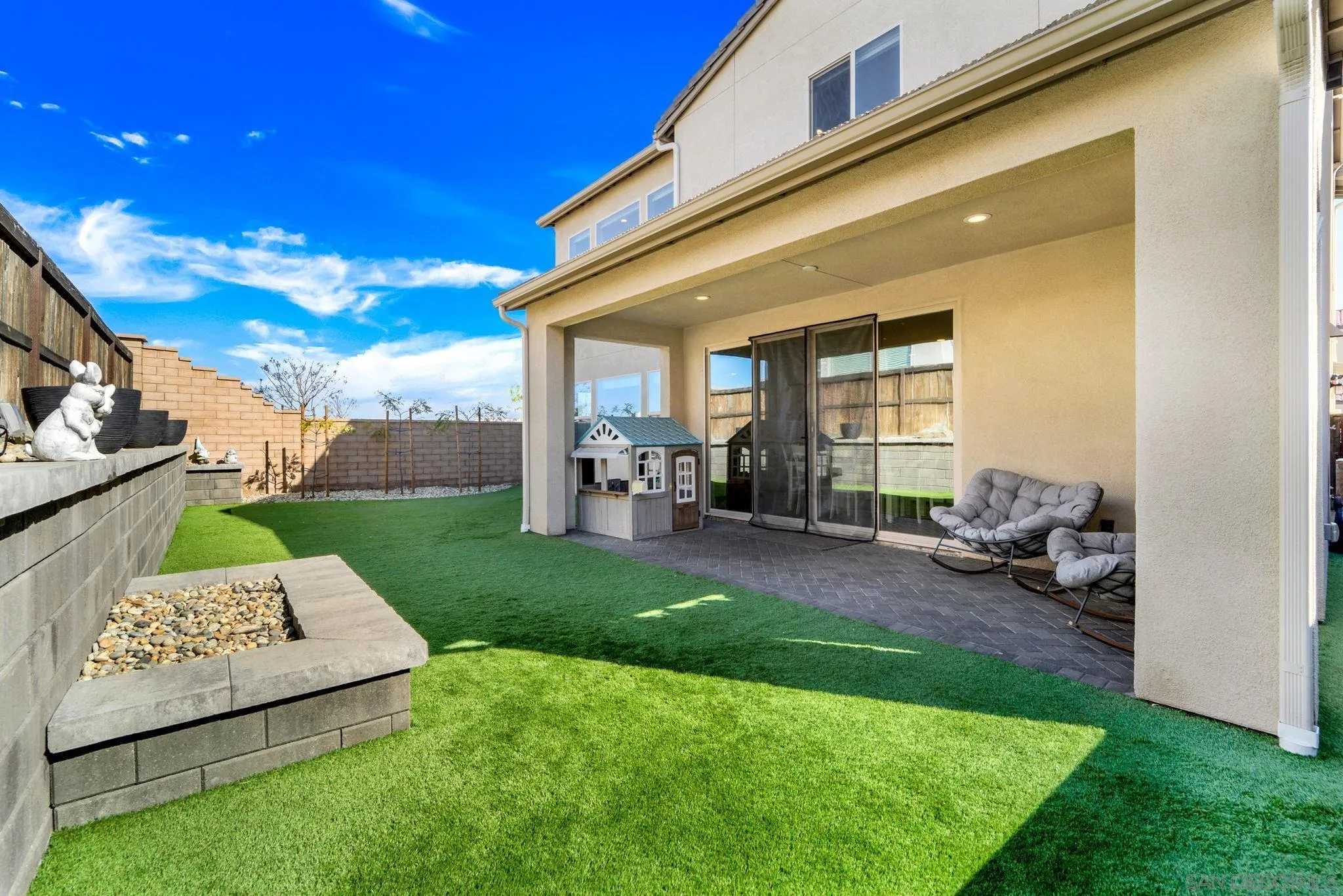1279 Camino Prado Chula Vista, CA 91913 - Photo 16 of 38 a view of a patio with couches chairs and a yard