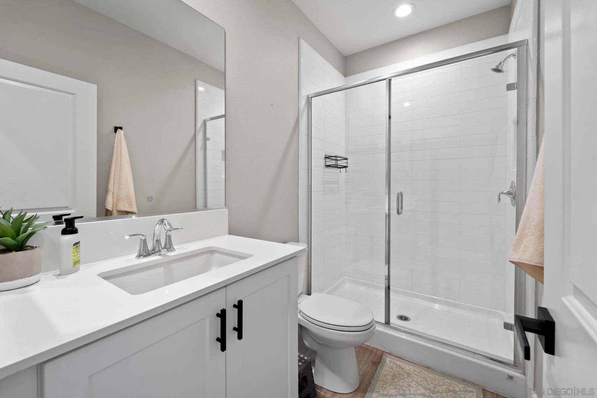 1279 Camino Prado Chula Vista, CA 91913 - Photo 20 of 38 a bathroom with a sink a toilet and shower