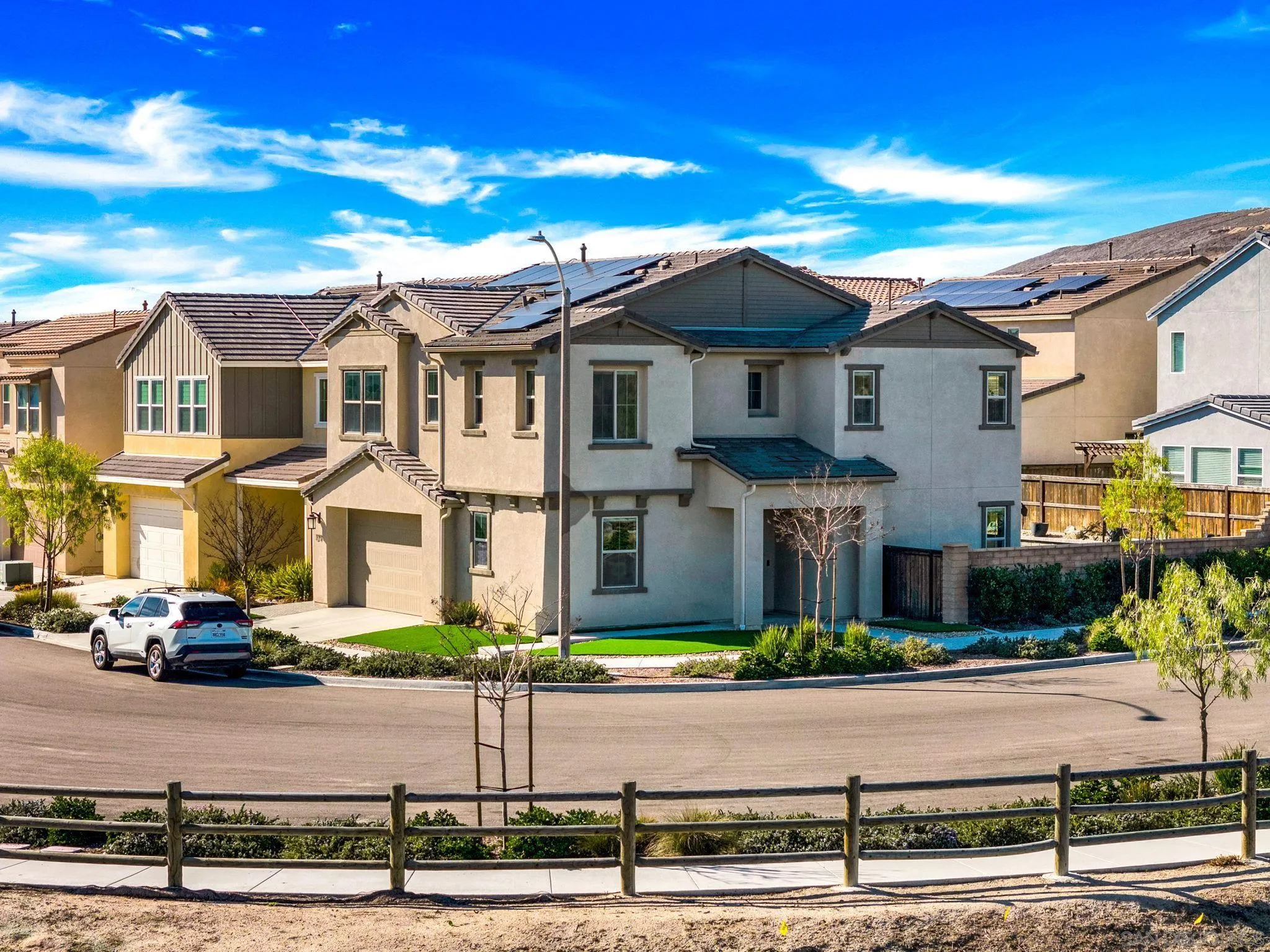 1279 Camino Prado Chula Vista, CA 91913 - Photo 2 of 38 a front view of residential houses with yard and road