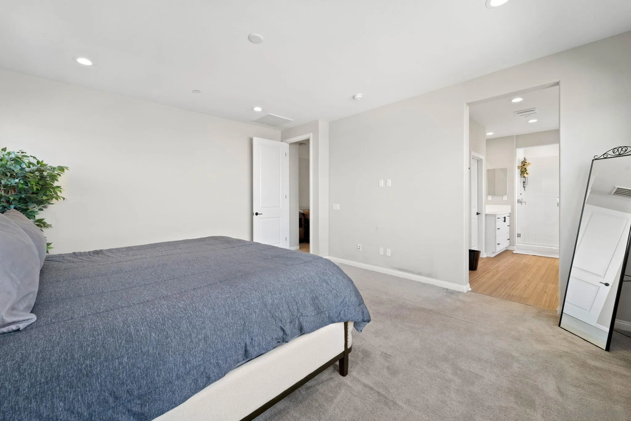 1279 Camino Prado Chula Vista, CA 91913 - Photo 25 of 38 a spacious bedroom with a bed and a potted plant