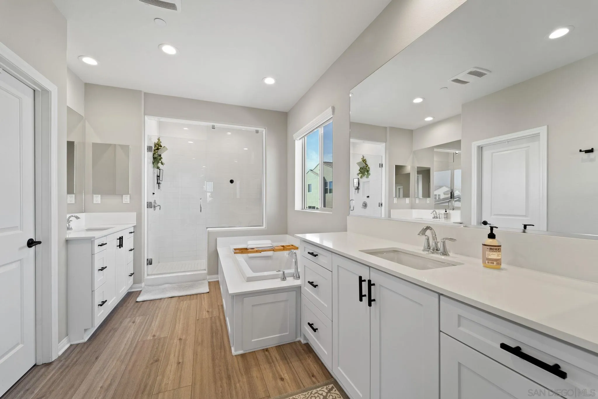 1279 Camino Prado Chula Vista, CA 91913 - Photo 26 of 38 a spacious bathroom with a double vanity sink a mirror a shower and a bathtub