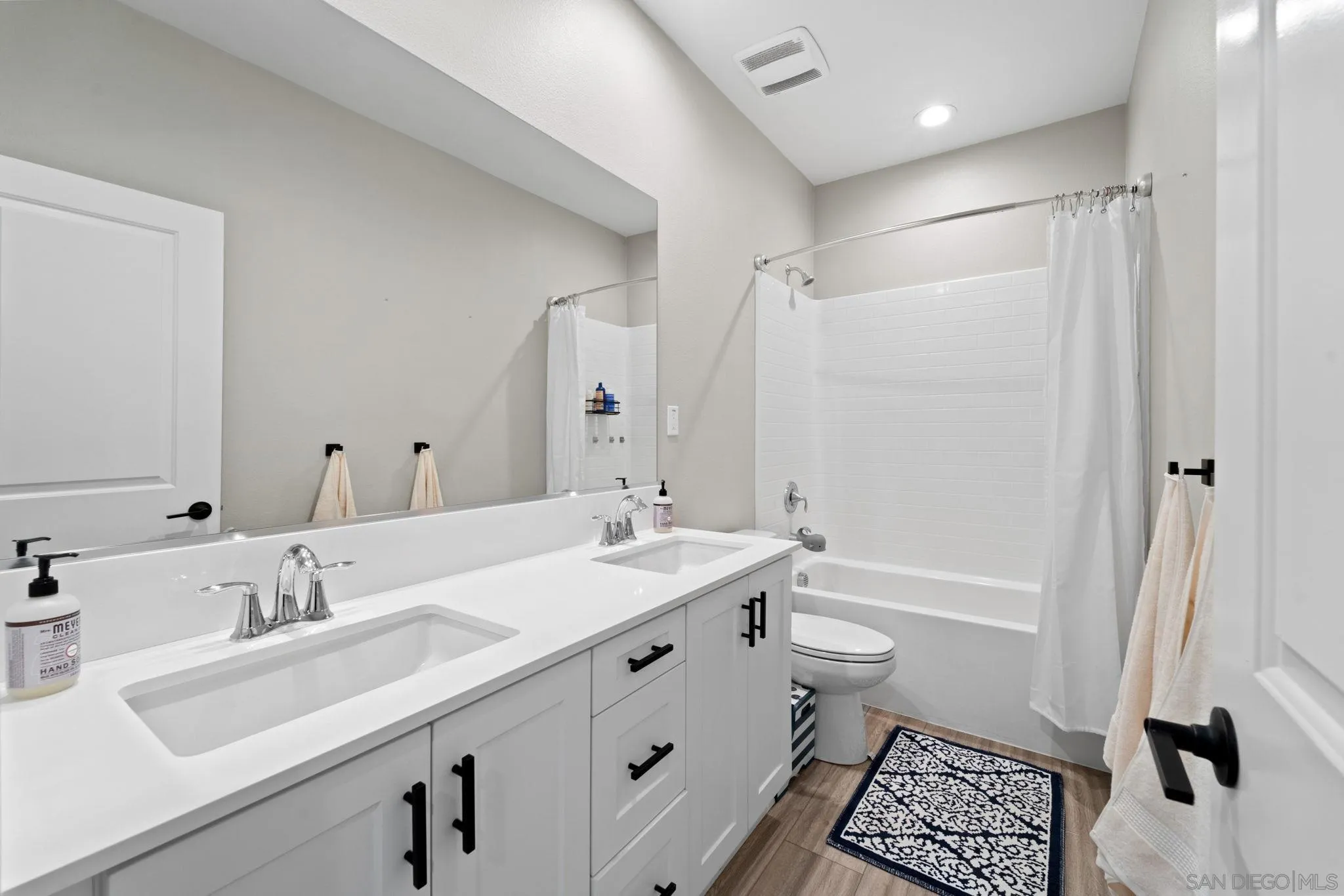 1279 Camino Prado Chula Vista, CA 91913 - Photo 31 of 38 a bathroom with a sink a toilet and a large mirror