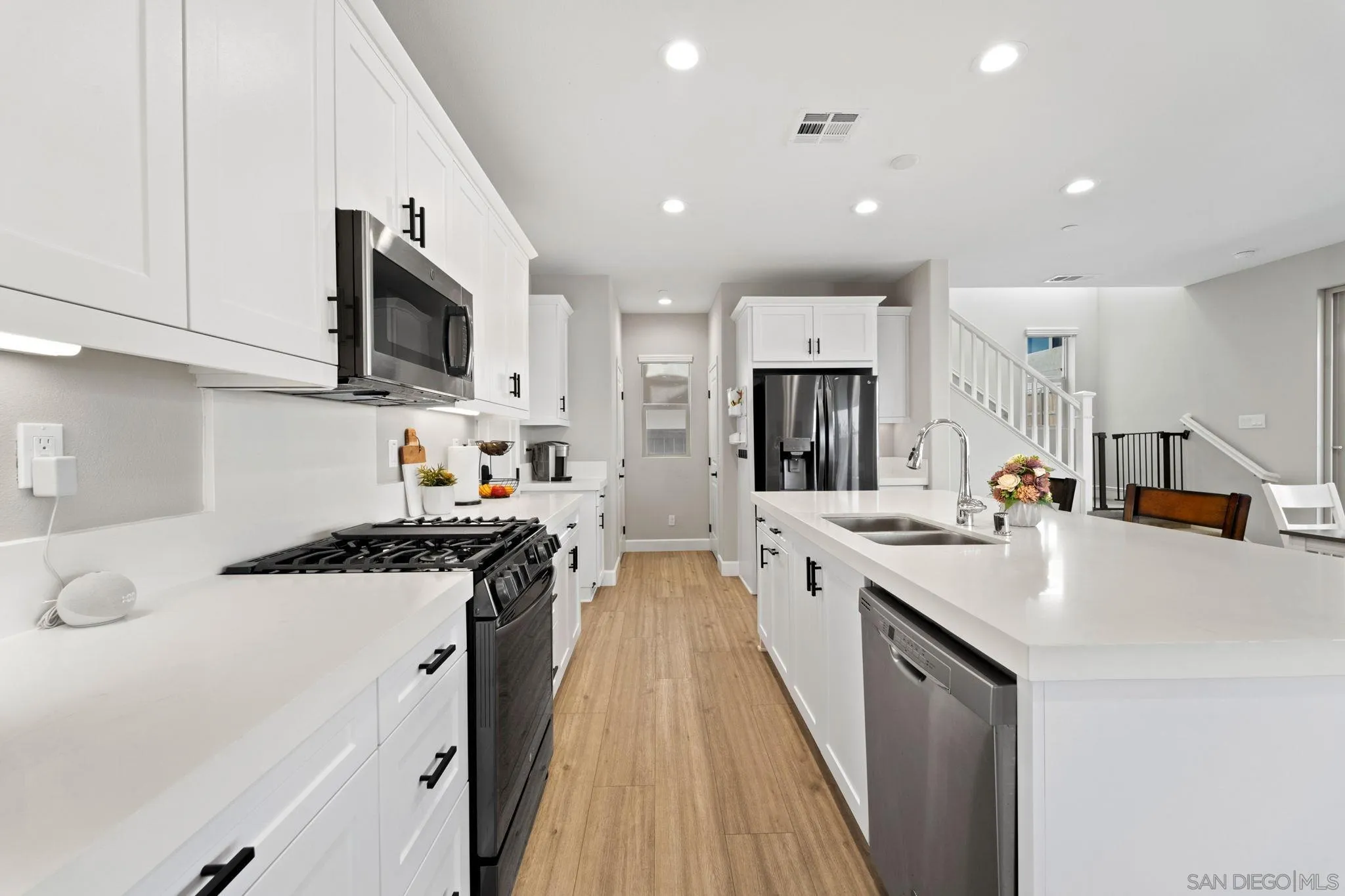 1279 Camino Prado Chula Vista, CA 91913 - Photo 8 of 38 a kitchen with a sink stove and cabinets