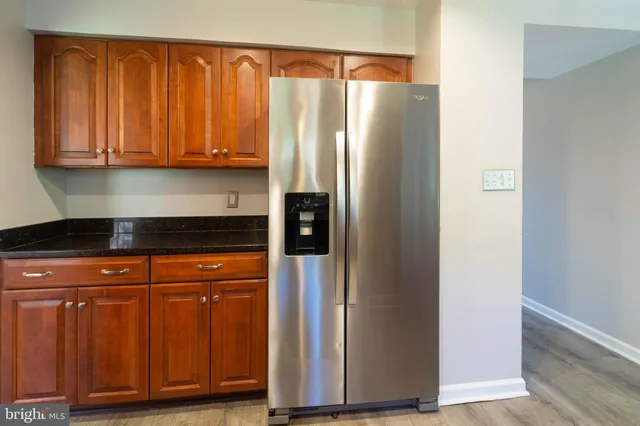 a kitchen with stainless steel appliances granite countertop a refrigerator and cabinets