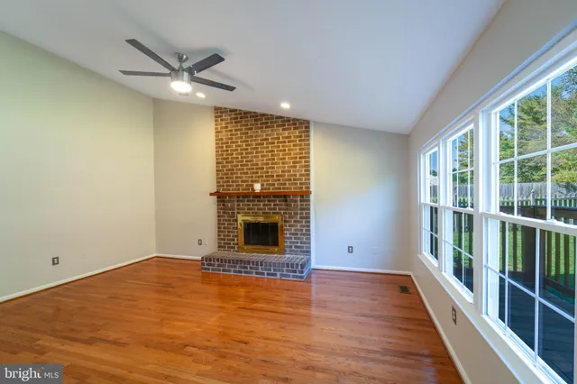 wooden floor in an empty room with a fireplace