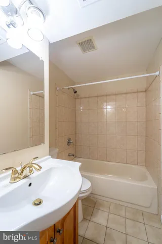 a bathroom with a tub a sink and a shower