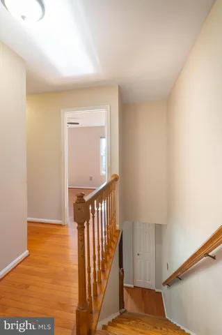 a view of a hallway with wooden floor and entryway