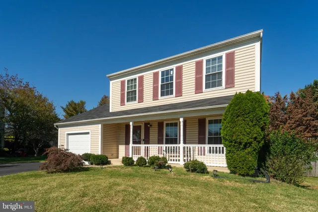 a front view of a house with a yard and porch