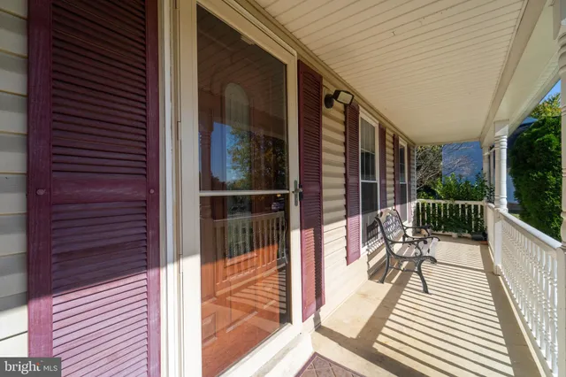 a balcony with chairs and wooden floor