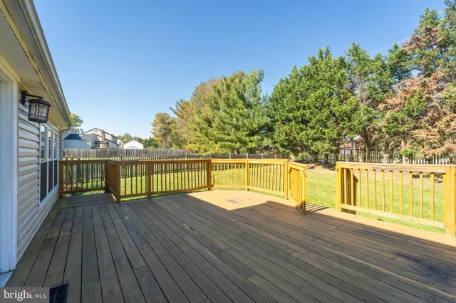 a view of a balcony with wooden floor and fence