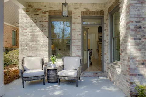 a view of a patio with couches and a dining table with chairs