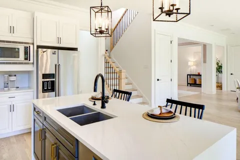a kitchen that has a table chairs and a wooden floor