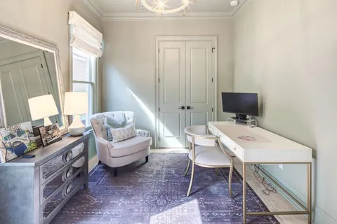 a living room with furniture a window and a table