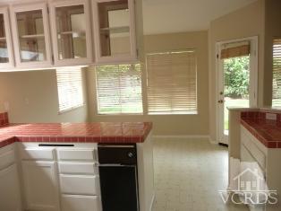 2409 Grapevine Drive Oxnard, CA 93036 - Photo 3 of 4 a kitchen with granite countertop cabinets and window