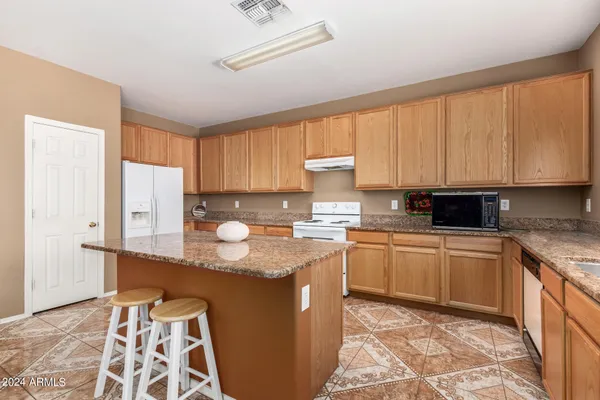 a kitchen with granite countertop a sink and a stove