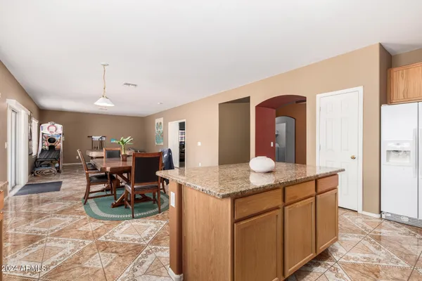 a kitchen with granite countertop a sink a stove and cabinets