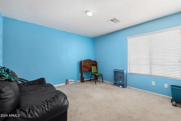 a bedroom with furniture and a chandelier
