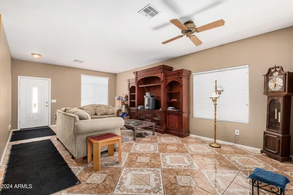 a living room with furniture a flat screen tv and a table
