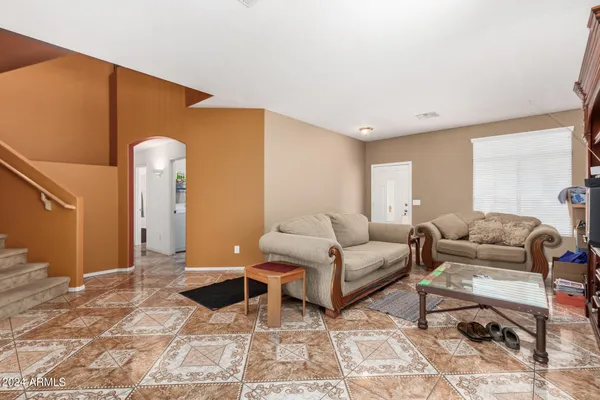a living room with furniture and a rug