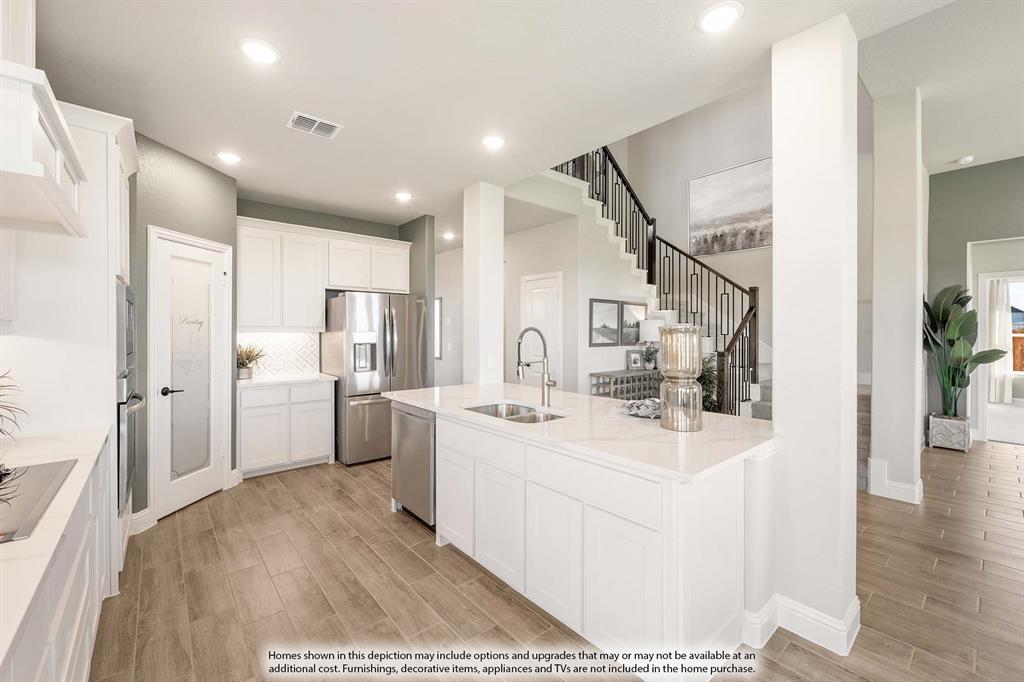 5214 Stone Lane Midlothian, TX 76065 - Photo 12 of 40 a kitchen with white cabinets and stainless steel appliances