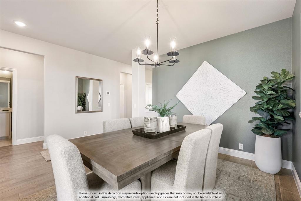 5214 Stone Lane Midlothian, TX 76065 - Photo 6 of 40 a dining room with furniture potted plants and wooden floor