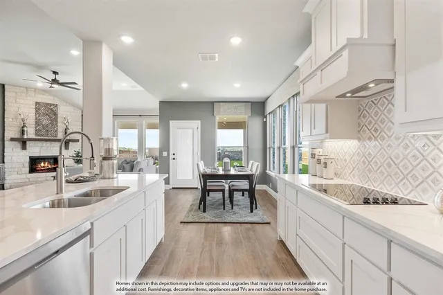 a large kitchen with kitchen island a sink stainless steel appliances and furniture