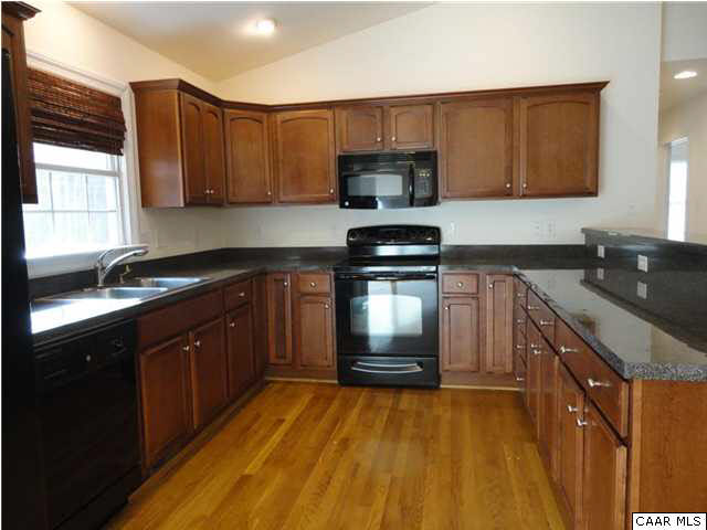 5347 Three Chopt Road Louisa, VA 23093 - Photo 3 of 19 a kitchen with stainless steel appliances granite countertop a sink stove and microwave