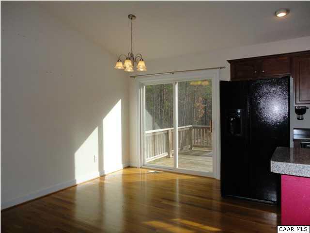 5347 Three Chopt Road Louisa, VA 23093 - Photo 4 of 19 a view of an empty room with wooden floor and a window