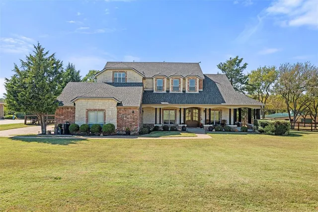 a front view of a building with a garden