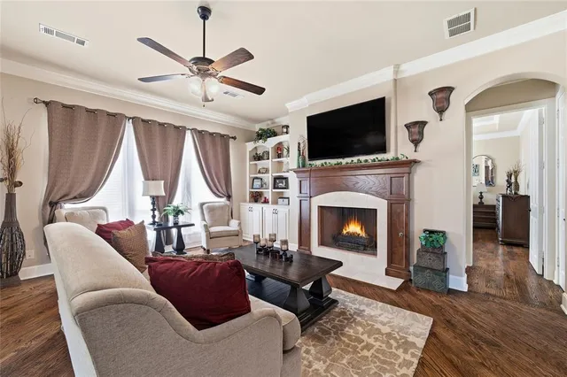 a kitchen with stainless steel appliances granite countertop a stove a sink dishwasher a refrigerator and a dining table with wooden floor