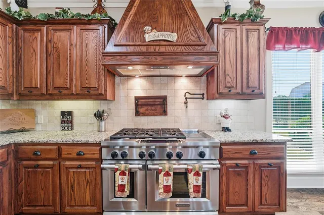 a kitchen with stainless steel appliances granite countertop a sink and a microwave