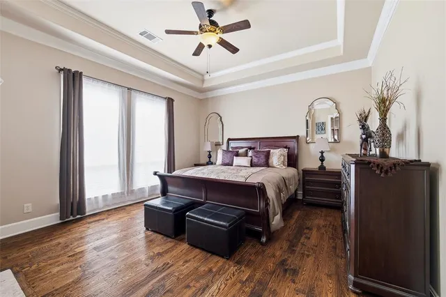 a living room with furniture and a ceiling fan