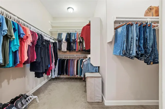 a spacious bedroom with a bed and a television