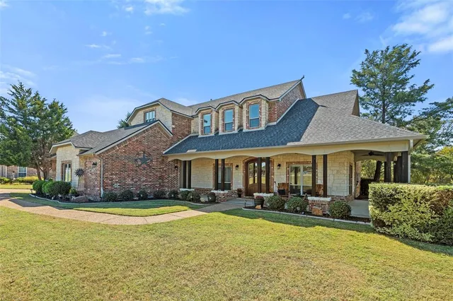 a front view of a house with a yard table and chairs