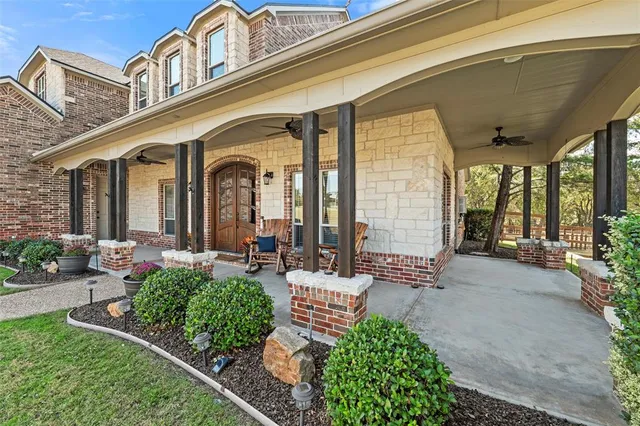 a front view of a house with garden and porch
