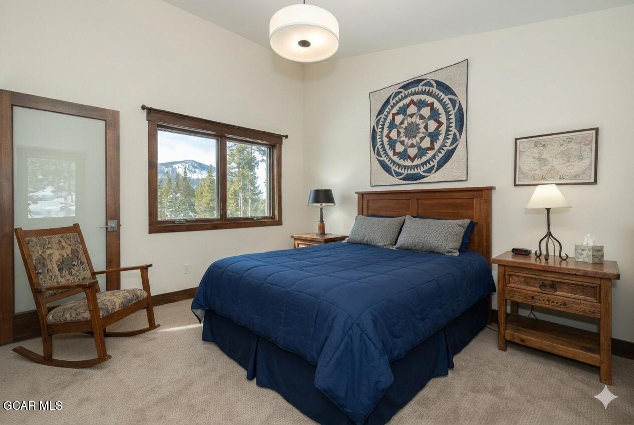 492 Mountain Peak Road Tabernash, CO 80478 - Photo 12 of 29 a bedroom with a bed a mirror and a window