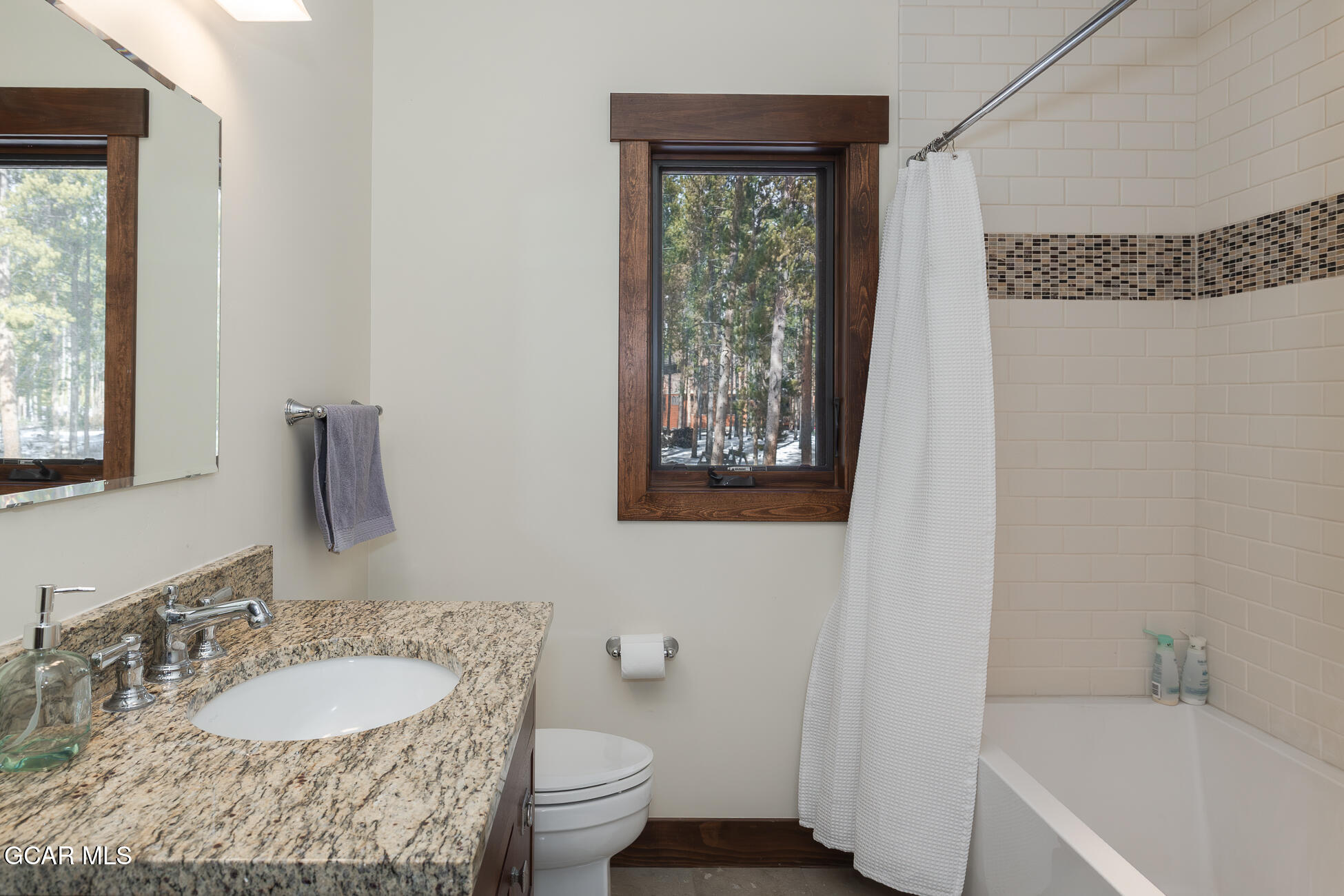 492 Mountain Peak Road Tabernash, CO 80478 - Photo 13 of 29 a bathroom with a granite countertop sink toilet and mirror