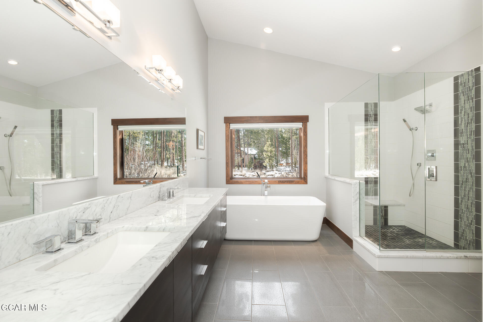 492 Mountain Peak Road Tabernash, CO 80478 - Photo 9 of 29 a spacious bathroom with a granite countertop tub sink and mirror