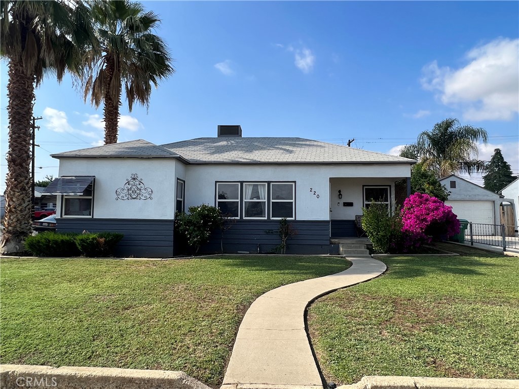220 El Tejon Avenue Bakersfield, CA 93308 - Photo 1 of 1 a front view of a house with a yard and garage