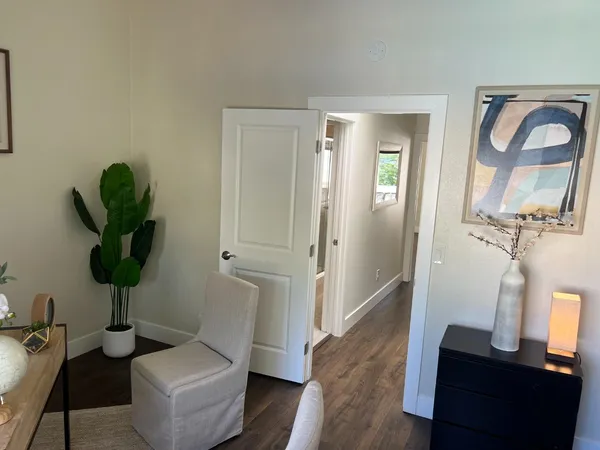 a view of hallway with livingroom and furniture