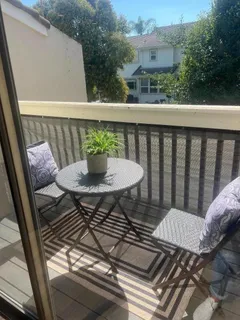a balcony with a table and chairs