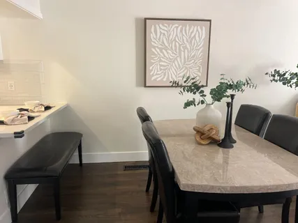 a dining room with furniture and wooden floor
