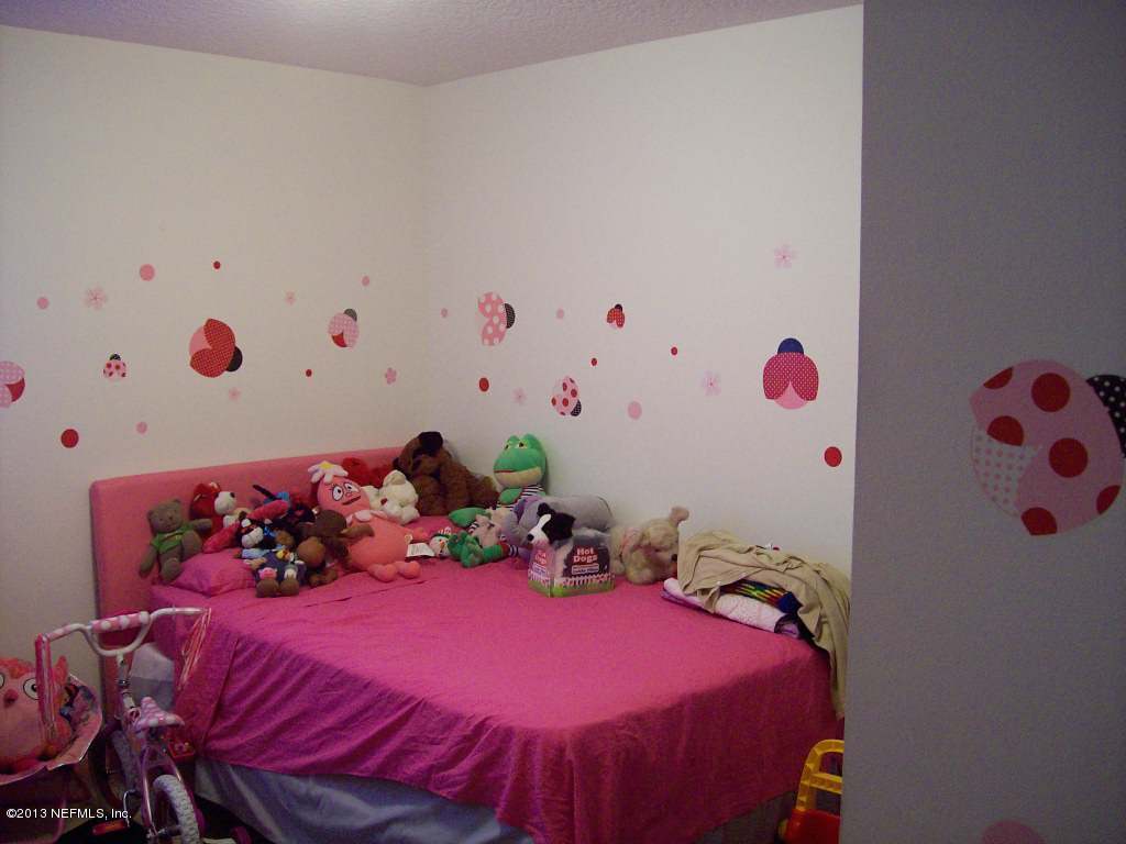9183 Raptor Drive Jacksonville, FL 32221 - Photo 12 of 13 a bedroom with a bed and a window