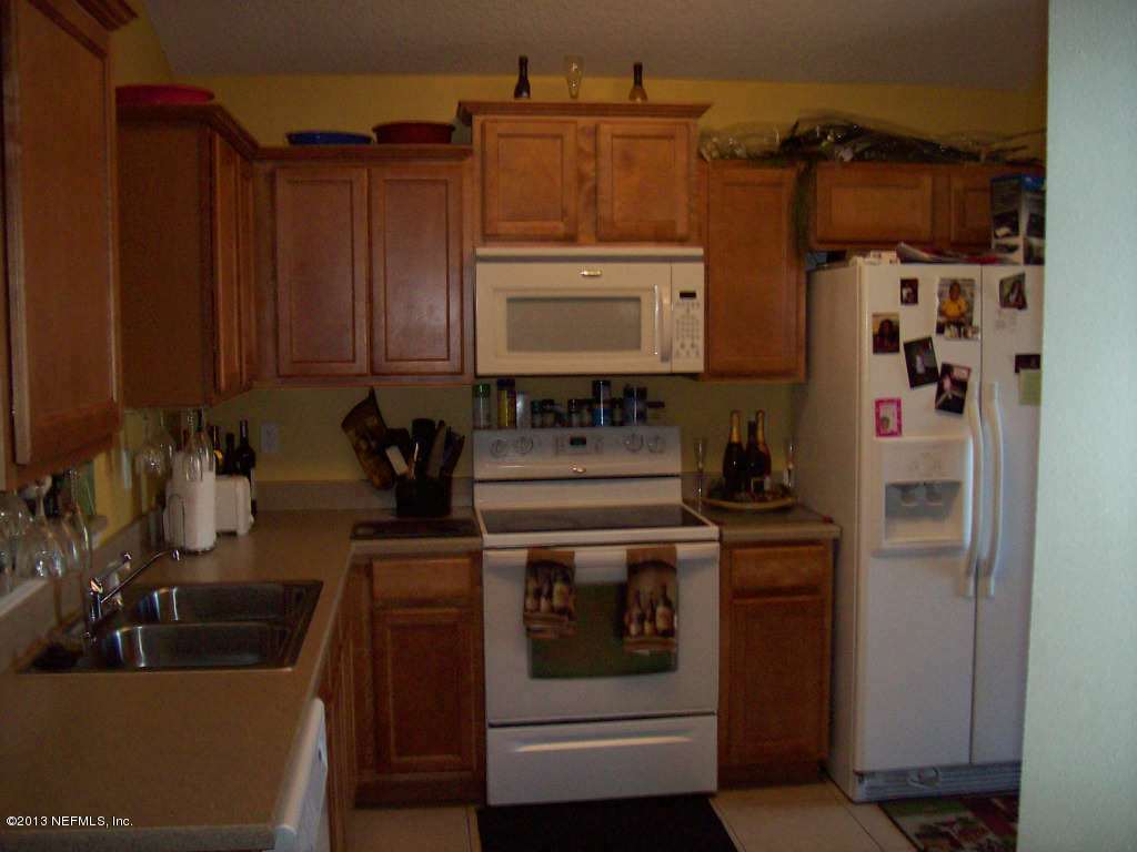 9183 Raptor Drive Jacksonville, FL 32221 - Photo 6 of 13 a kitchen with stainless steel appliances granite countertop a sink stove and refrigerator