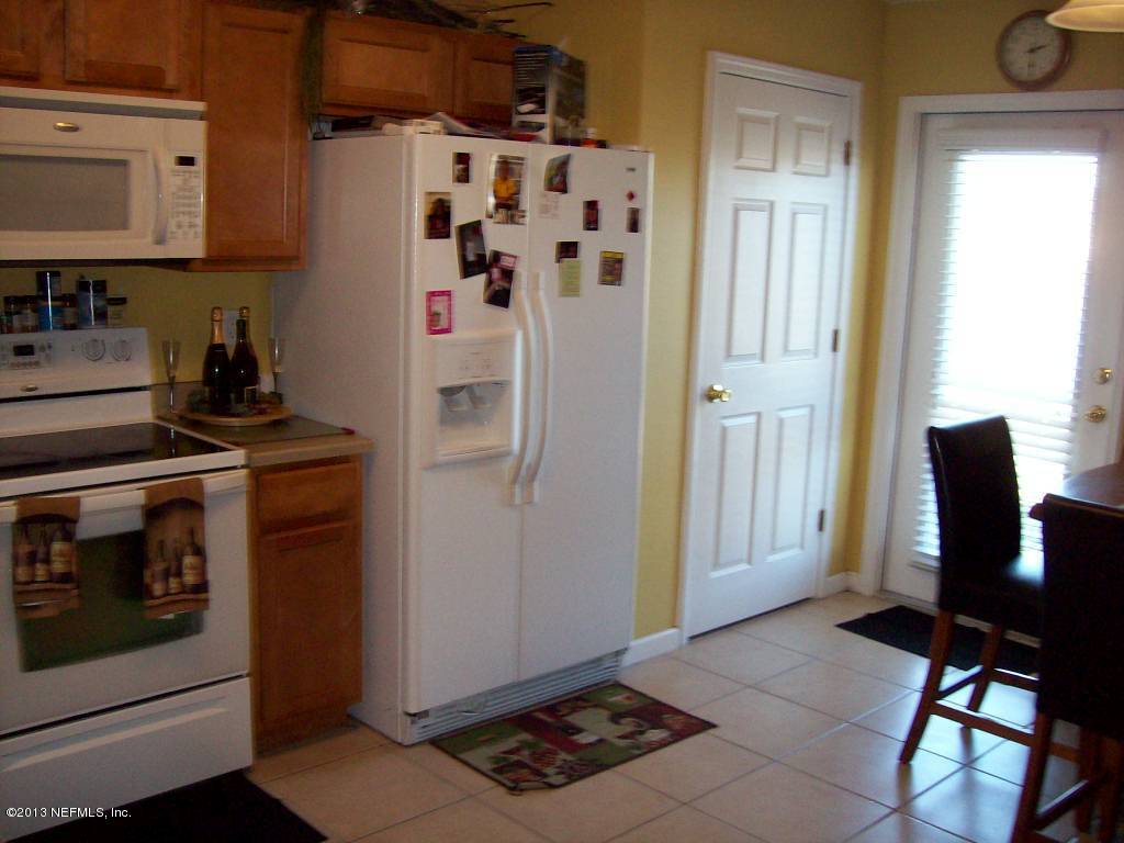 9183 Raptor Drive Jacksonville, FL 32221 - Photo 7 of 13 a view of kitchen with refrigerator stove and window